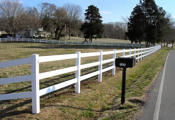 White vinyl ranch rail fence along a residential property